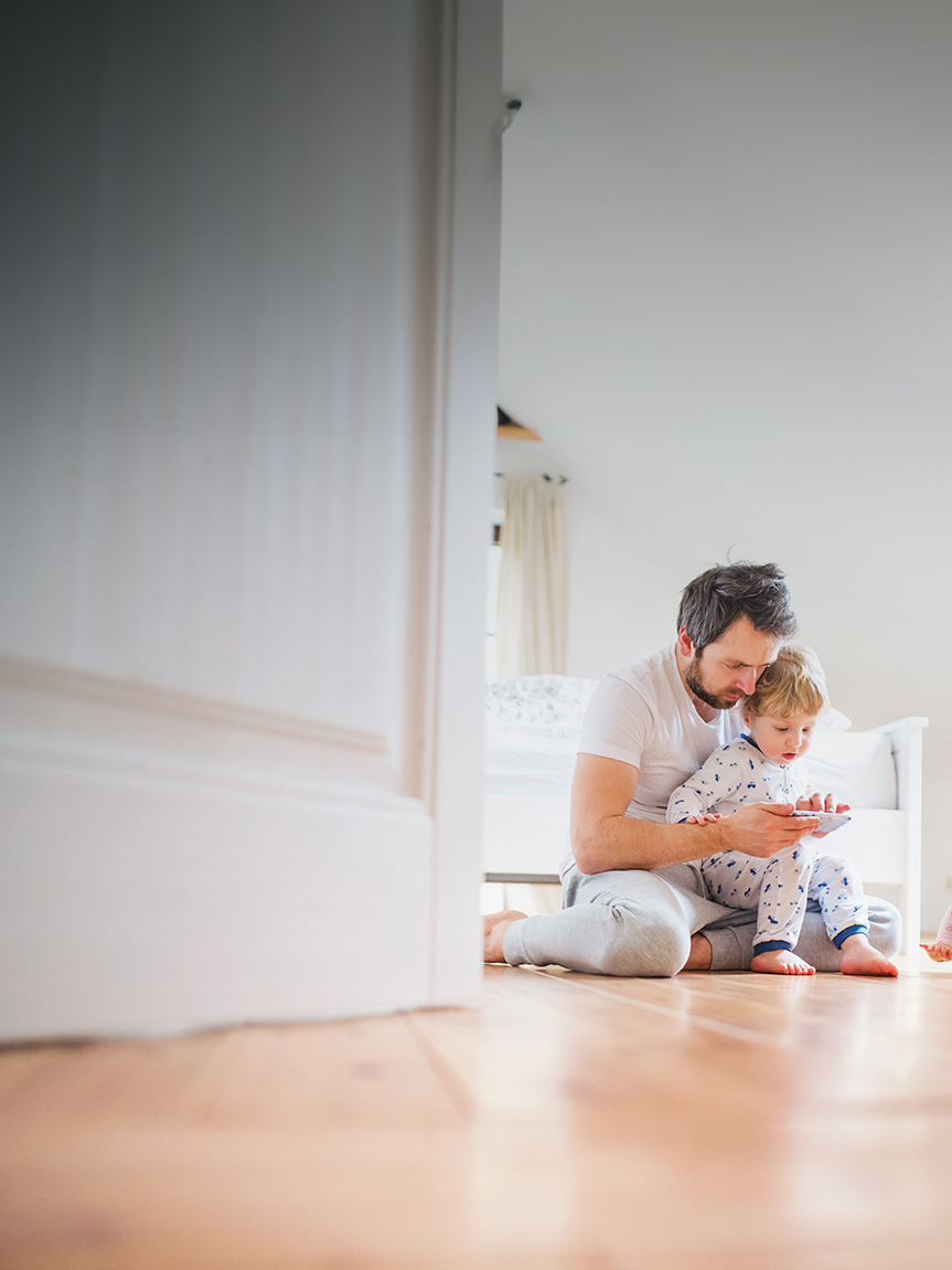 Mom and daughter playing with tablet on hard surface floors